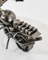 close up of wheel detail on motorbike sculpture