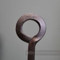 Hand wrought handle on shovel for fireplace