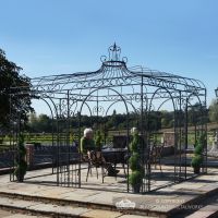 Black metal garden gazebo on slab patio
