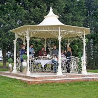 Cream garden gazebo on patio octagonal shape