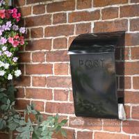 Newspaper post box mounted on wall