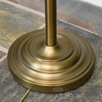 Close up of large round antique bronze base on floor lamp