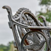 Close up of Aged Black "Dog" Single Seater Bench