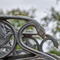 Close up of Aged Black "Dog" Bench embellishments
