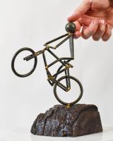 Scale image of stunt cycling recycled metal and wood sculpture