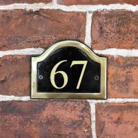 Vinyl Black & Brass Arched Number Sign in Situ on a Brick Wall