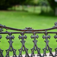 Close up of Aged Black Cast Iron Gothic Backrest Design