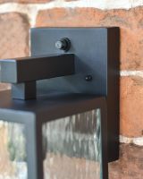 Black Contemporary Wall Light Mounted Flush on to a Brick Wall 