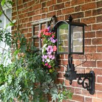 Black Four Sided Lantern On Scrolled Wall Bracket
