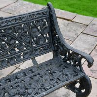 Close up of Aged Black Cast Iron Garden Bench