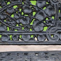 Close up of leaf design on Aged Black Cast Iron Bench