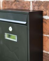 Close-Up of Modern Black Rectangular Steel "POST" Wall Mounted Post Box with Lock