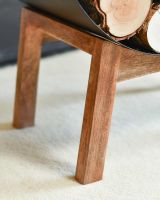 Close-Up of Wooden Legs for Black Round Steel "Barrel" Log Holder