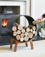 Scale Shot of Black Round Steel "Barrel" Log Holder with Wooden Legs