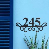 Traditional Iron Ornate Number Sign on a Blue Wall