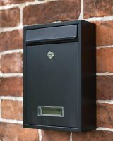 Slim Black Lockable Wall Mounted Post Box in Use on a Brick House