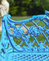 Close up of ornate leaf detailing on cast iron garden bench