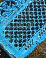Close up of intricate seat detailing on cast iron garden bench