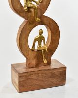 Close up of aluminium gold figure detail on mango wood base