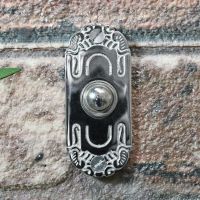 Beautiful art Nouveau inspired door bell on brick wall