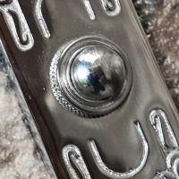 Close up image of front door buzzer button
