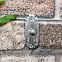 Beautiful metal House buzzer on brick wall