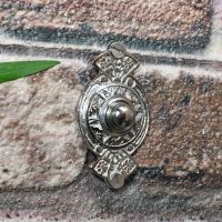 Chrome Classical Ornate door Bell Push on brick wall