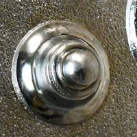 Close up of bright chrome door buzzer