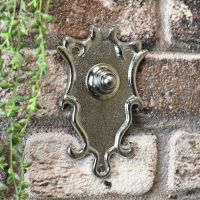 Door entry bell push finished in bright chrome