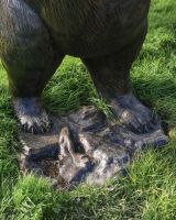 Close up of base of bear sculpture