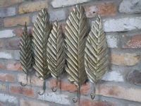 Brushed Gold Leaf-Shaped Hook Rack on Brick Wall