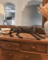 Side view of bronze leopard