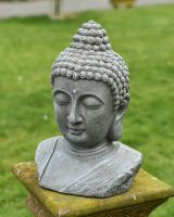 Angled view of buddha bust garden sculpure