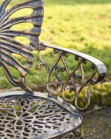 Close Up Of Butterfly Design Two Seater Bench Arm Rests