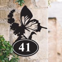 Bespoke Butterfly Iron House Number Sign on a Garden Wall