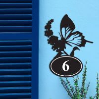 Butterfly Iron House Number Sign in Situ on a Blue Wall 