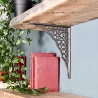 Cast Iron Trellis Patterned Shelf Bracket Holding up a Wooden Shelf