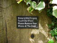 "Remove Your Shoes" Cast Iron Wall Sign in Situ