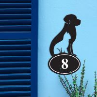 Cat & Dog Iron House Number Sign in Situ on a Blue Wall