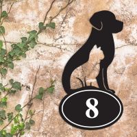 Cat & Dog Iron House Number Sign in Situ a Rustic Wall