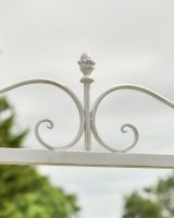 Close up of ornate scrollwork detail on champagne swing seat 