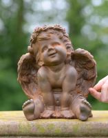 Scale of Cast Iron Smiling Cherub Garden Sculpture