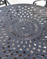 Close up of the lattice and ornate pattern on the table.