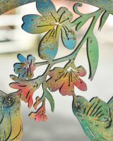 Close up of colourful floral steel detail on garden wall art mirror