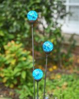 Close up of blue suncatcher plant pot stakes