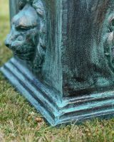 Close up of intricate face detail on garden sundial column