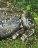 Close up of intricate trotter detail on brushed gold sleeping pig garden statue