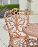 Close up of ornate chair back detail on outdoor furniture set