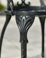 Close up of ornate chair leg detail on two seater garden table and chairs set