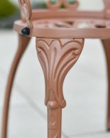 Close up of ornate chair leg detail on patio table and chairs set